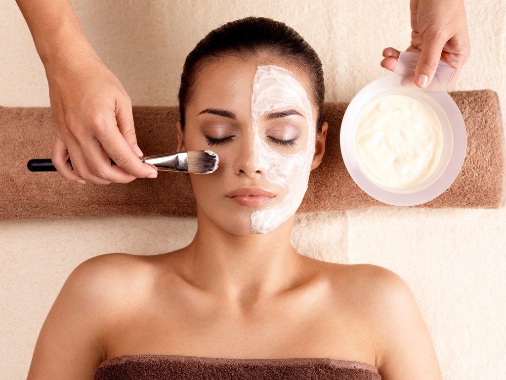 Woman having a facial mask at a salon