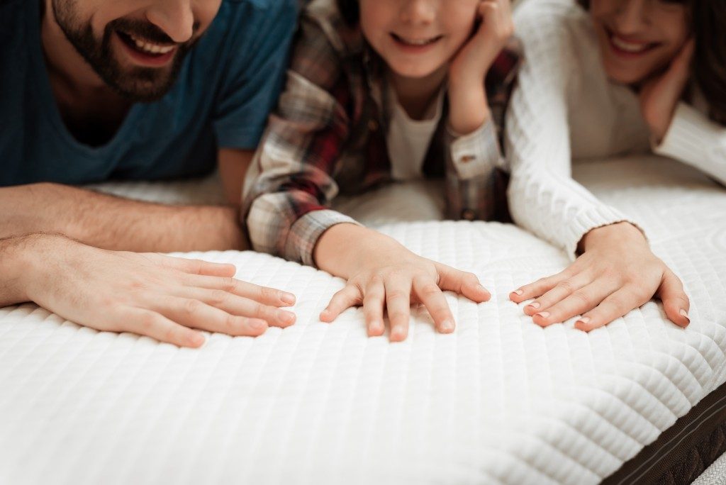 family lying on the bed