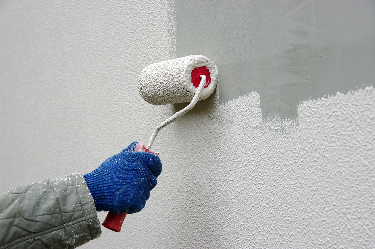 person painting the wall