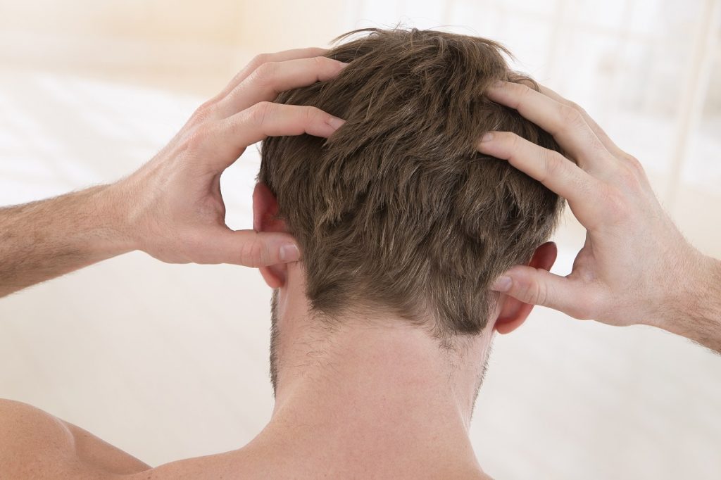 Man scratching scalp