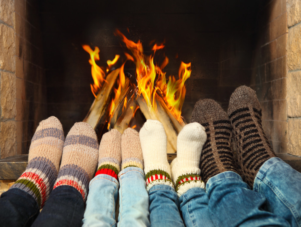feet of family in front of the fireplace with their woolen socks