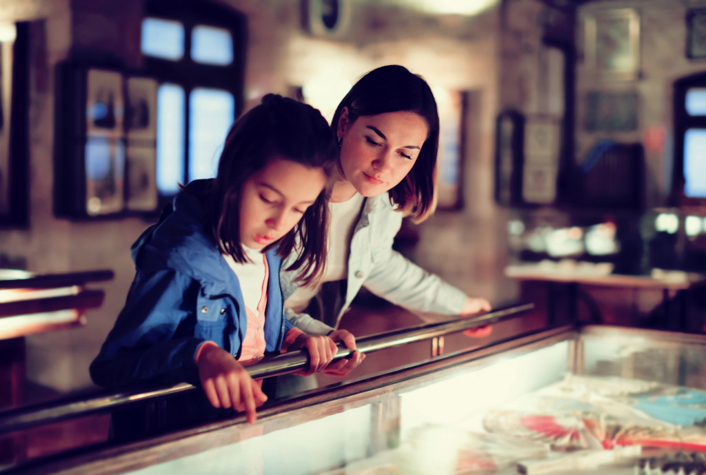 Mother and daughter look at museum exhibits