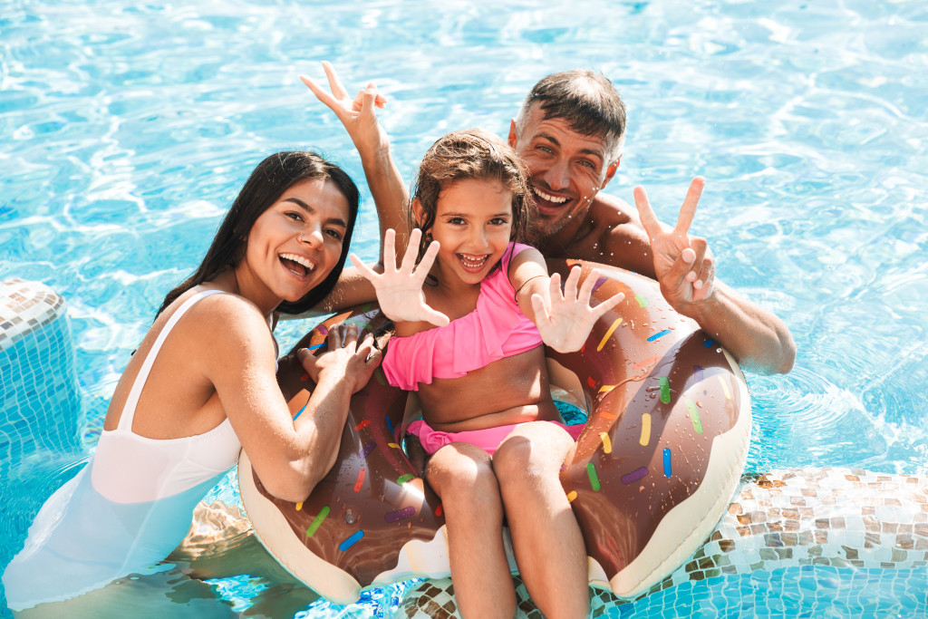 Parents and their child in a swimming pool