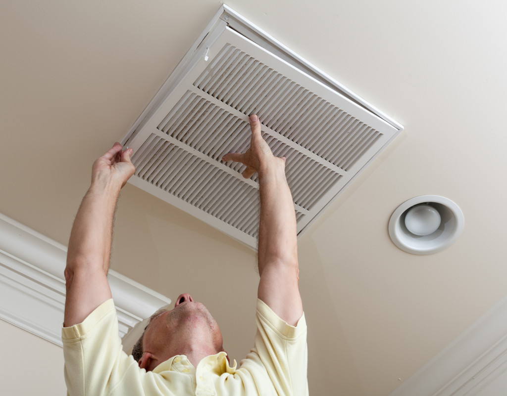 male homeowner opening air filter