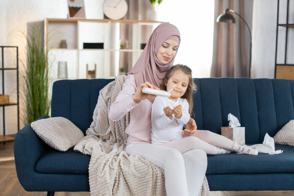 a mother and her little daughter using a skin product