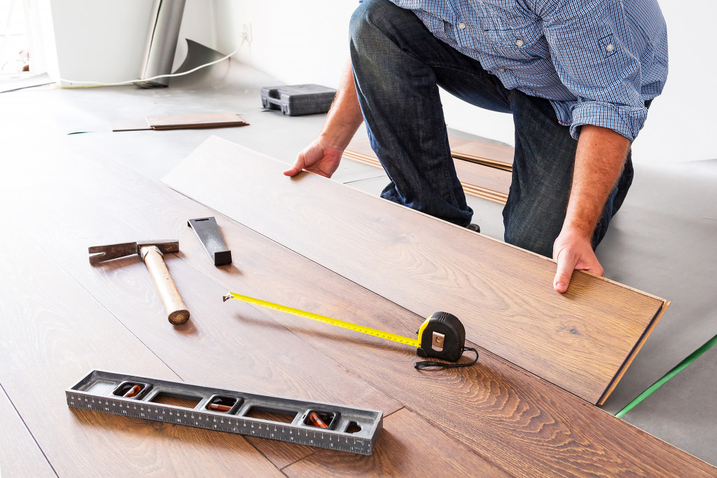 Wooden floor installation with various tools