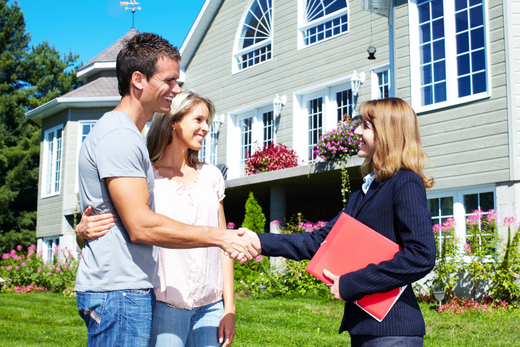 a man and woman getting on a deal with a real estate agent