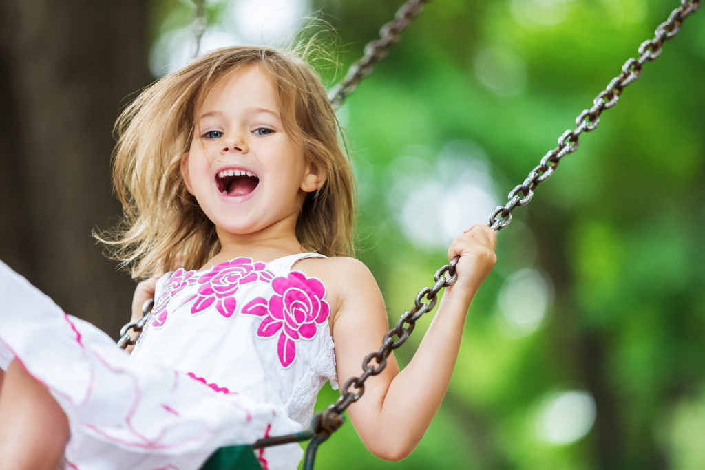 A child playing on a swing