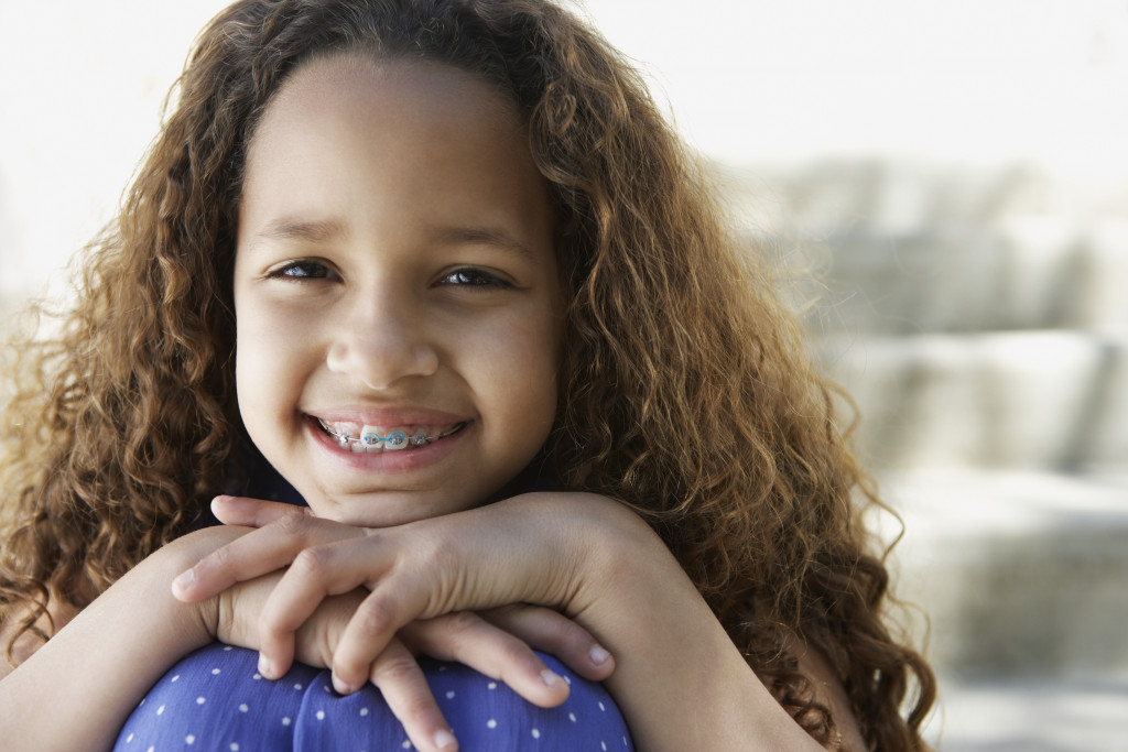 young girl with dental braces smiling