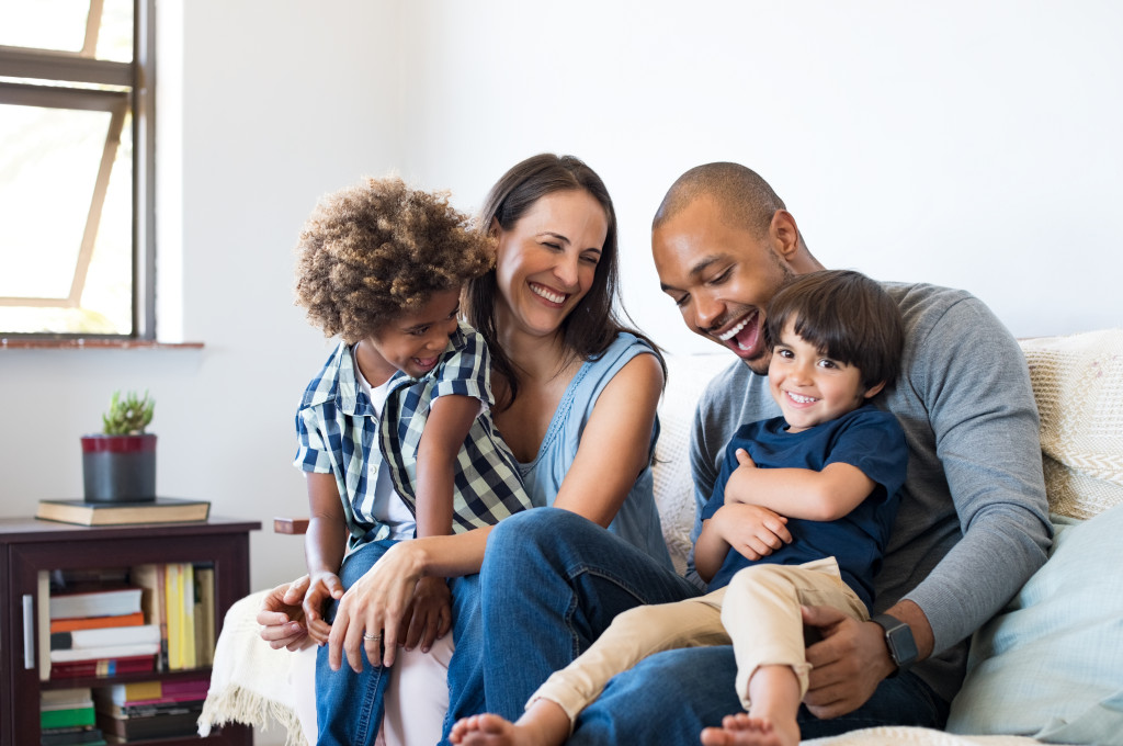 Parents having a light moment with their children at home.