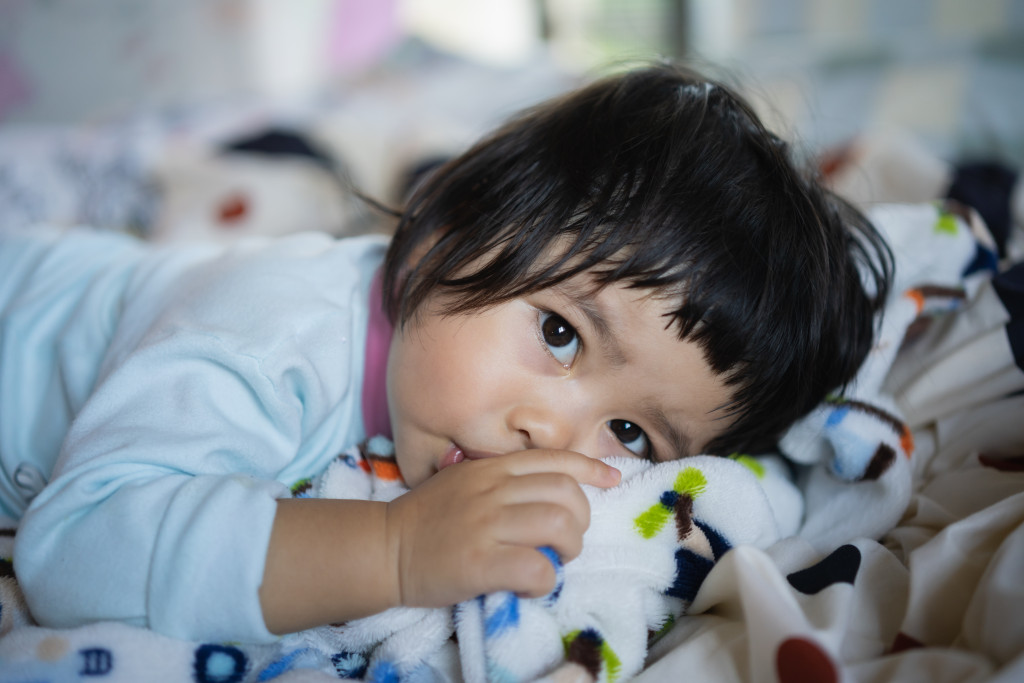 cute little girl in bed sucking her thumb