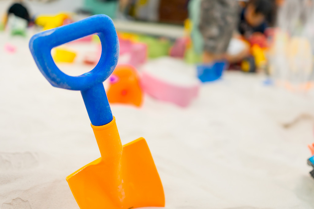 A sandbox with colorful plastic shovel