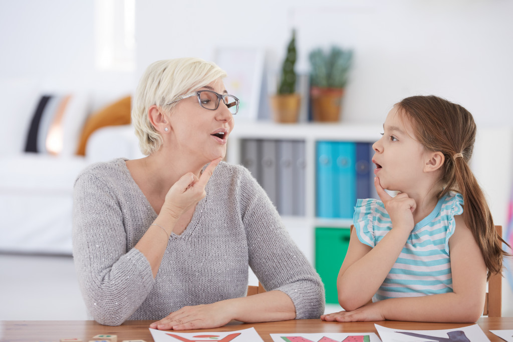 a young girl talking to a professional therapist