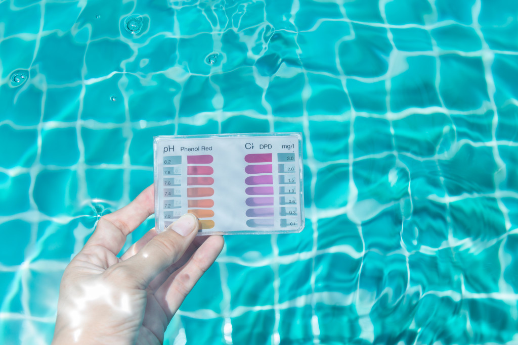 Testing the water quality of a swimming pool.