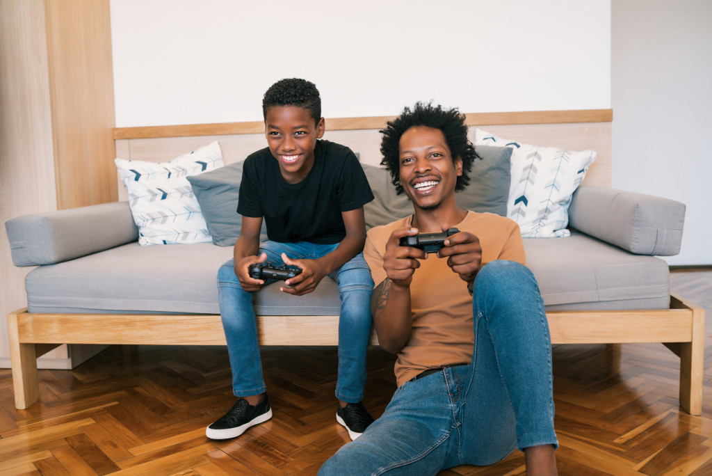 A parent and child playing video games