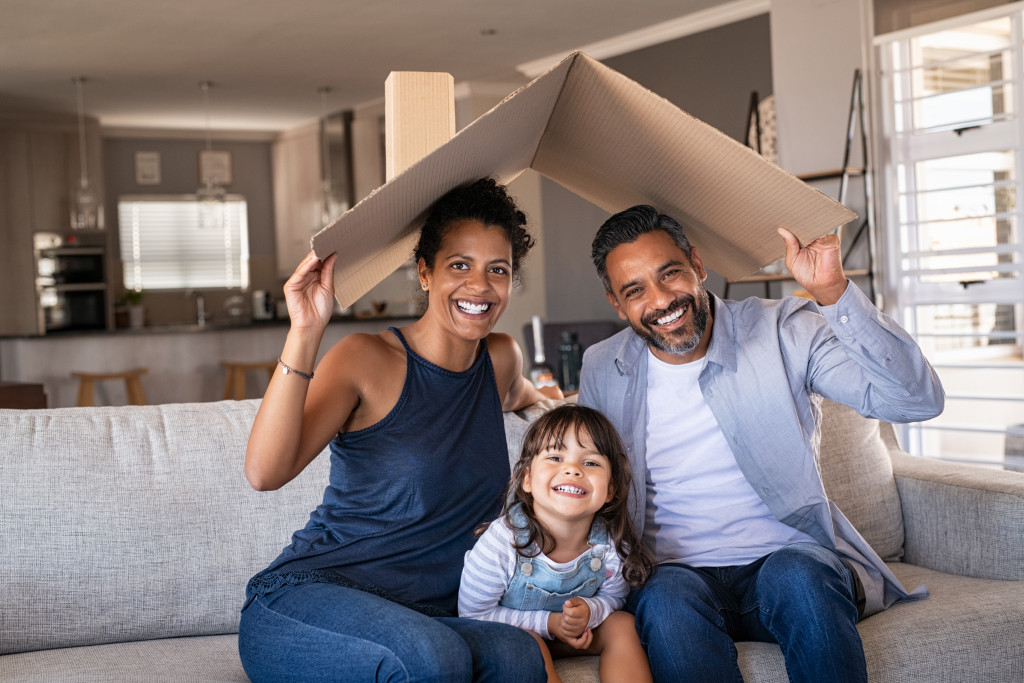 a young family at home with cardboard roof