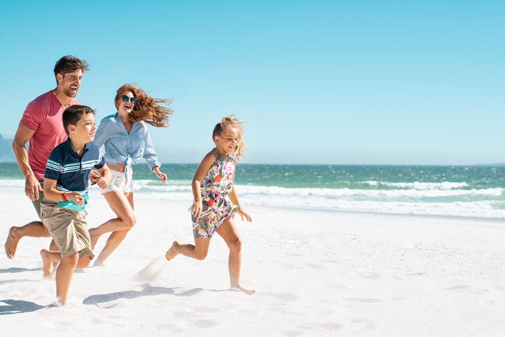 Parents and children having fun at the beach.