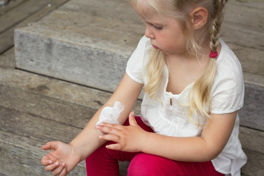 a child with bandage on her hand
