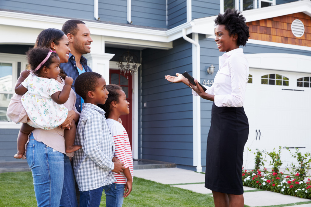 real estate agent showing a house to a family
