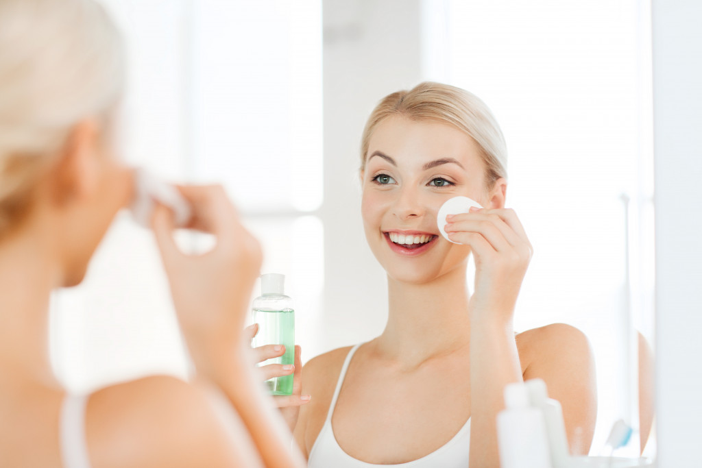 A woman cleansing her face