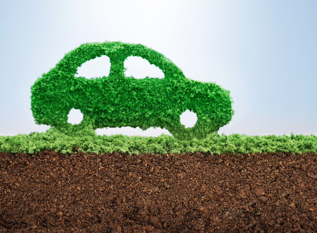 A miniature car made of grass running on soil