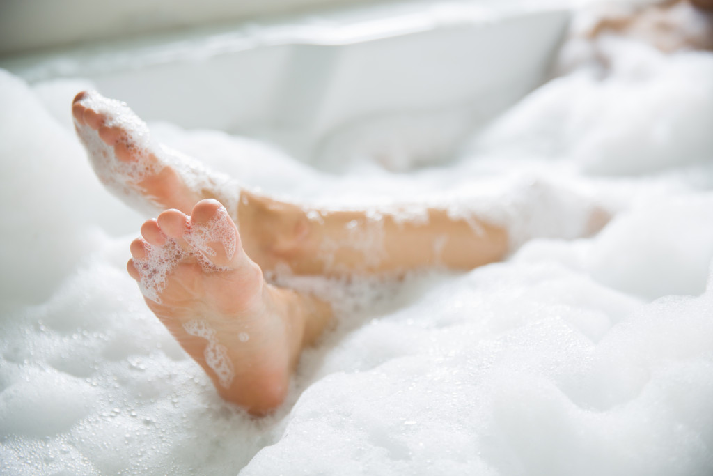 A woman bathing in a bathtub