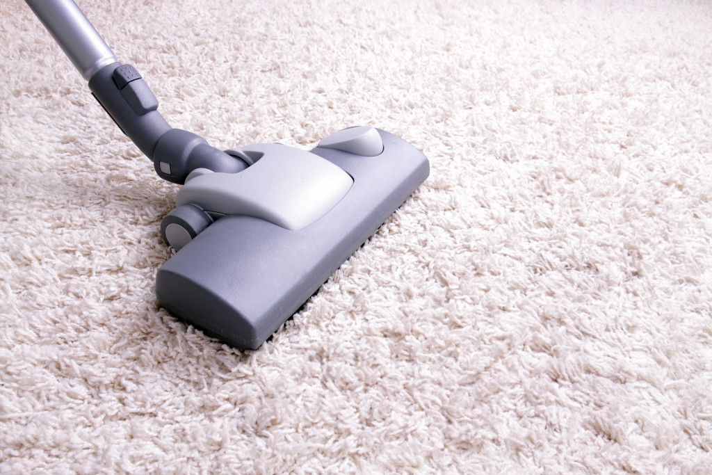 A vacuum extension on a fur carpet