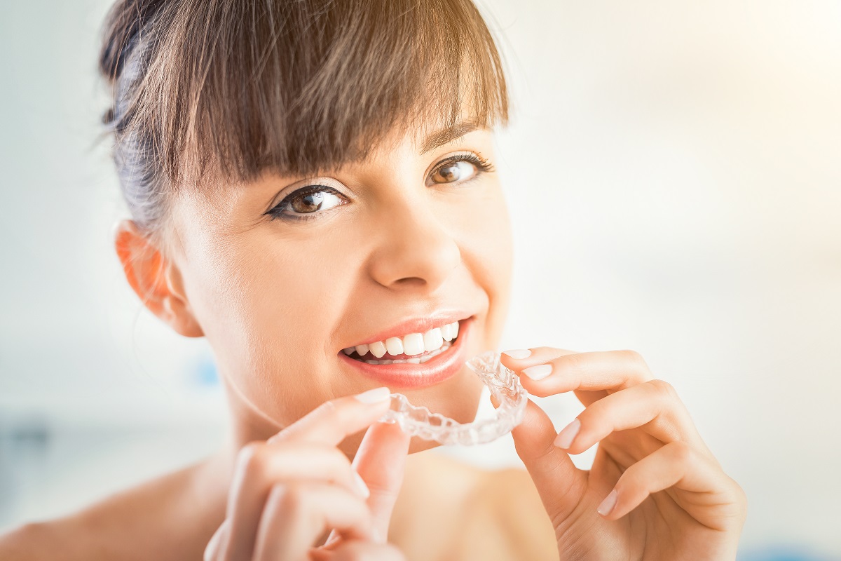 woman wearing invisalign braces