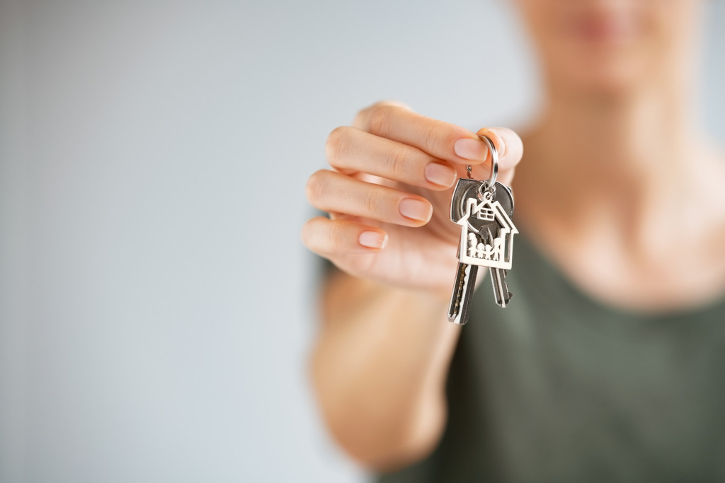 Agent giving keys to buyer