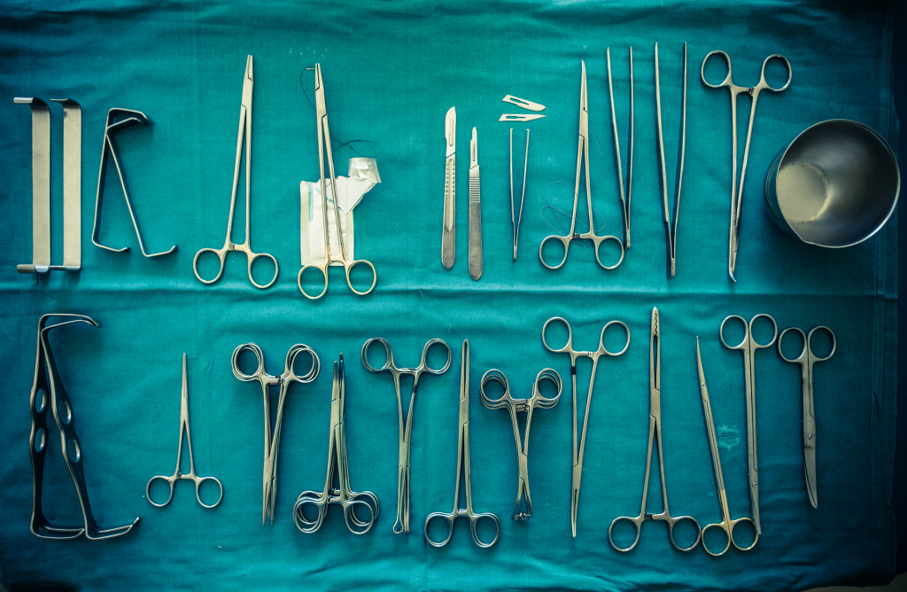 scalpels, forceps and tweezers arranged 