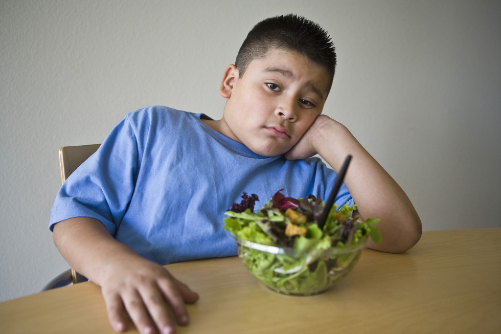 Obese child not wanting salad