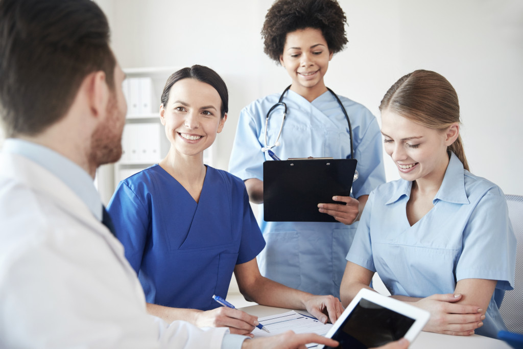 nurses and doctor having a conversation