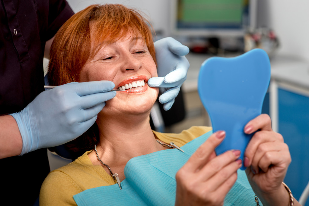  dental office and woman looking at the mirror