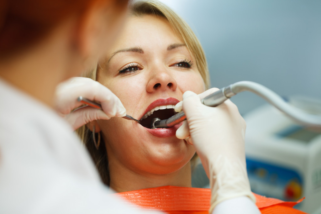 dentist checking on woman's mouth