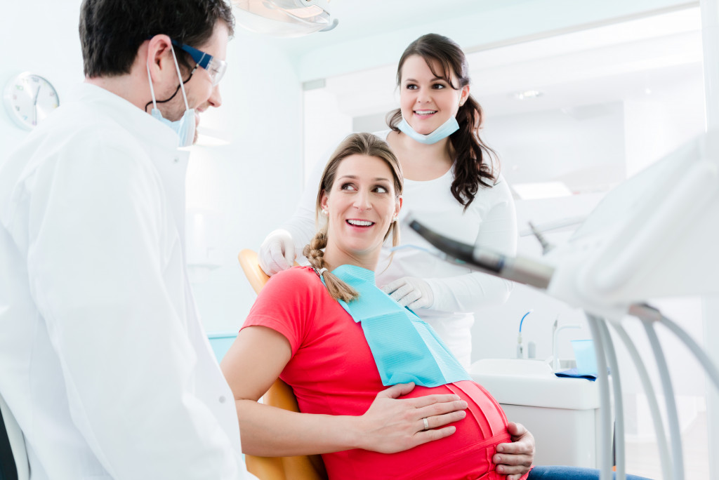 dentist with a pregnant patient in chair