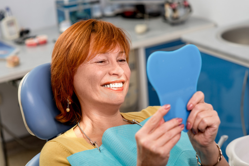  dental office and woman looking at the mirror