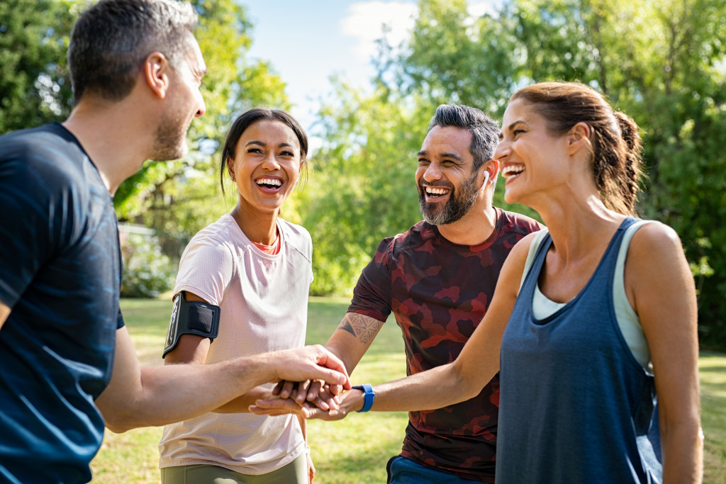 2 couples exercising at the park having fun