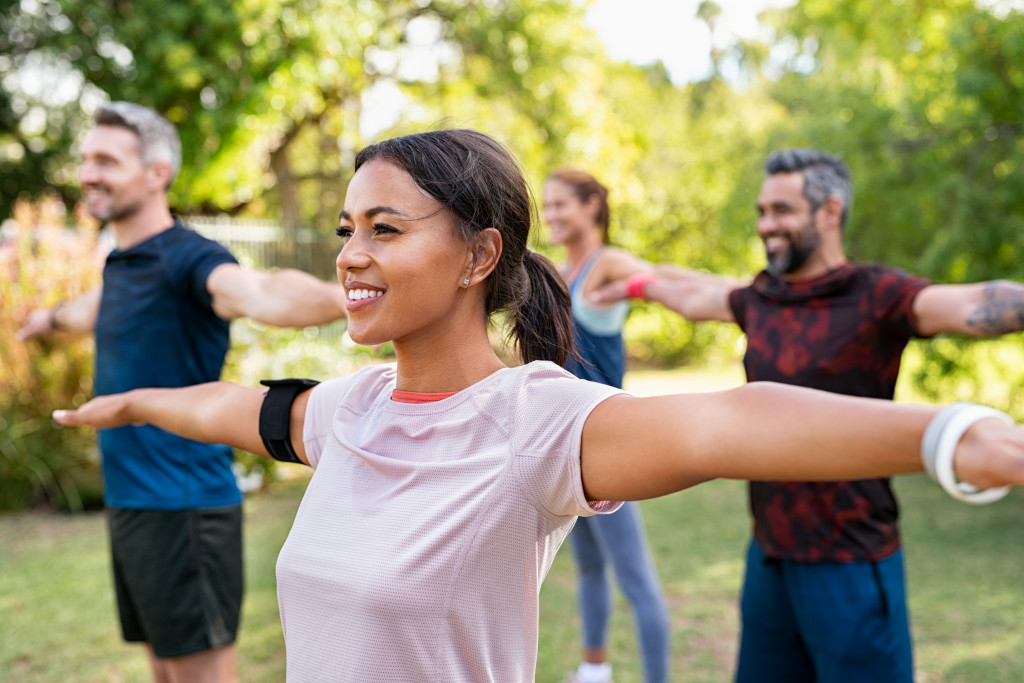 A group of people doing stretches outdoors