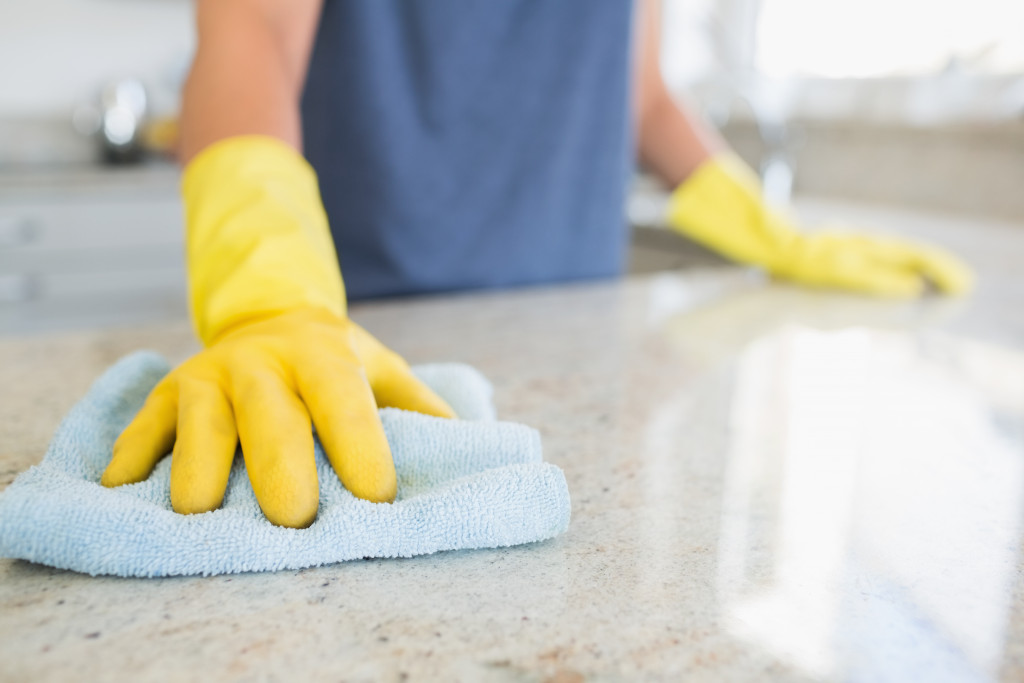 a person wearing cleaning gloves 