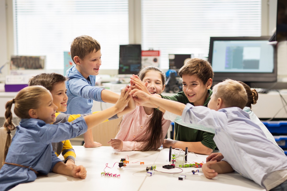 young friends team at the park high five