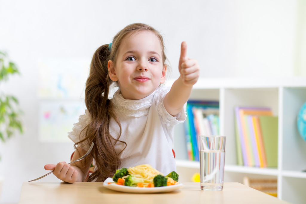 A young girl eating a healthy meal