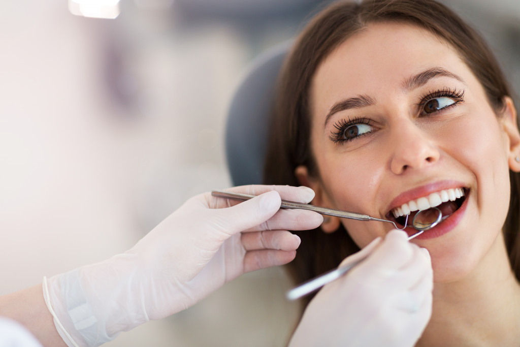 A dentist checking a patient's teeth