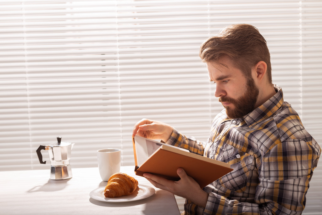 adult man reading a book