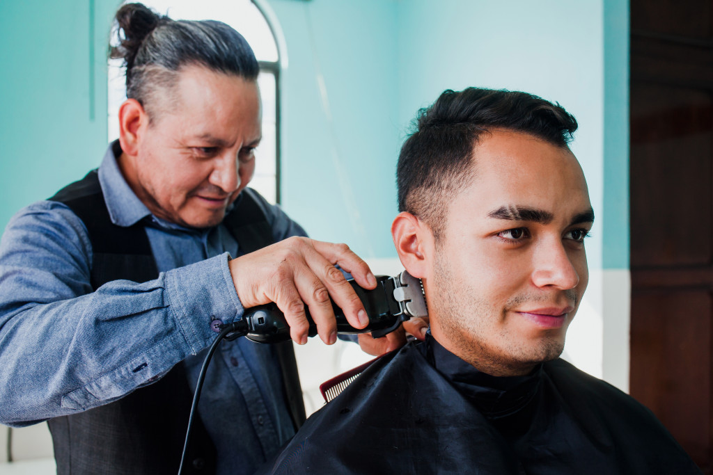 a barber giving a man a hair cut